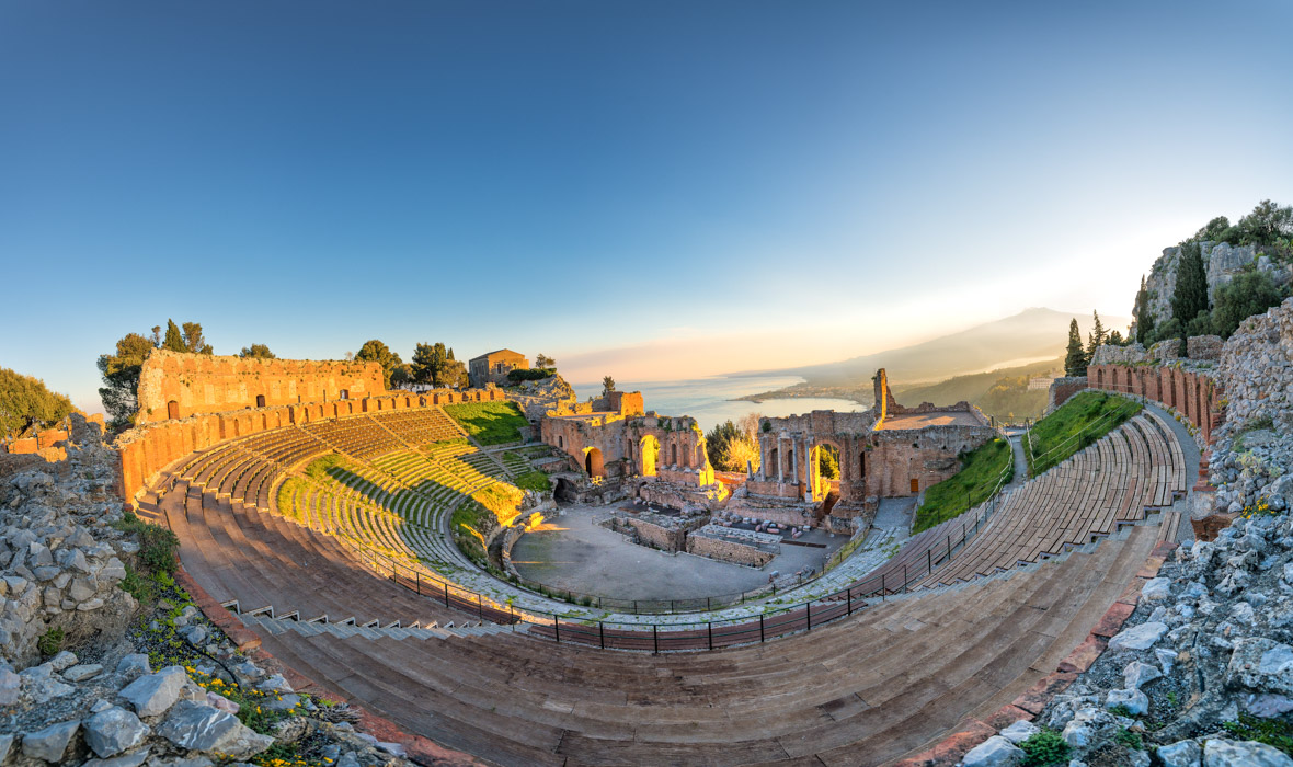 sustainability in traveling to the Ancient theatre of Taormina in the background the volcano Etna and the sea of Sicily Italy