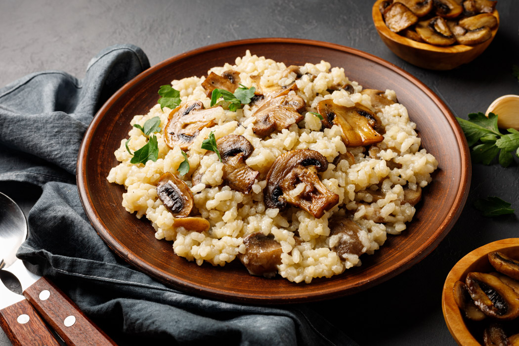traditional italian cuisine - risotto from rice and mushrooms