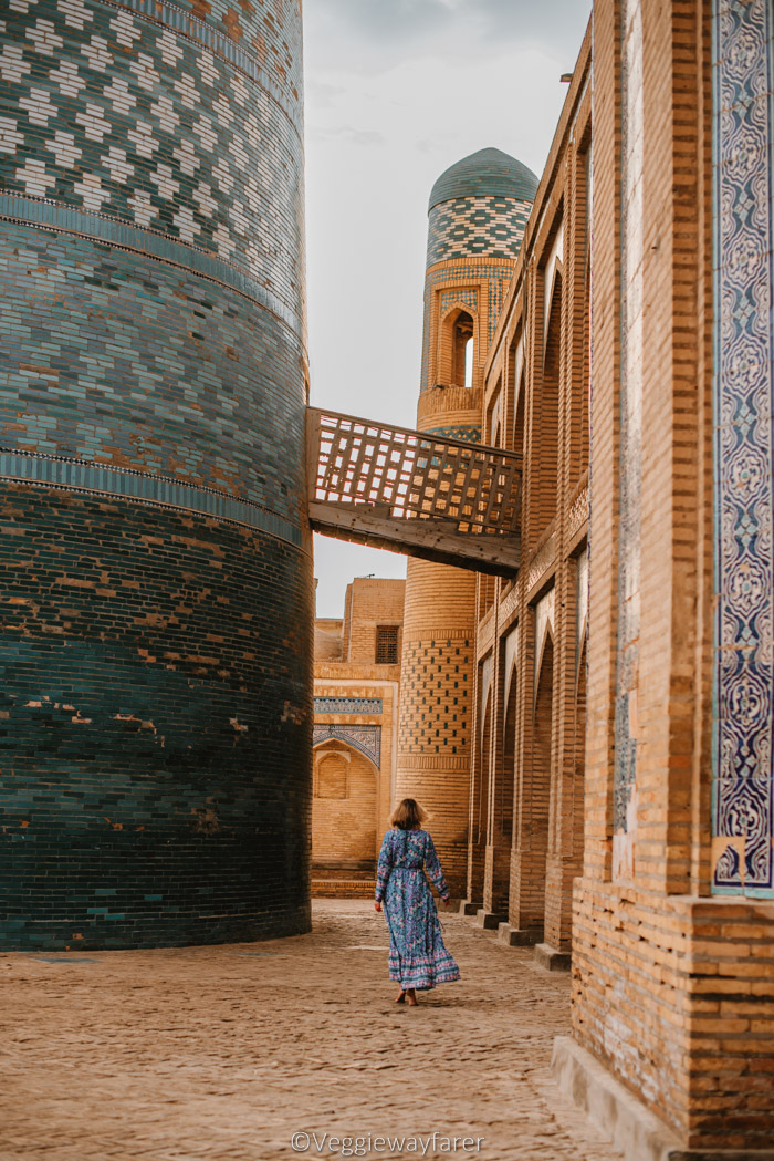 girl walking at the Kalta Minor Minaret in uzbekistan
