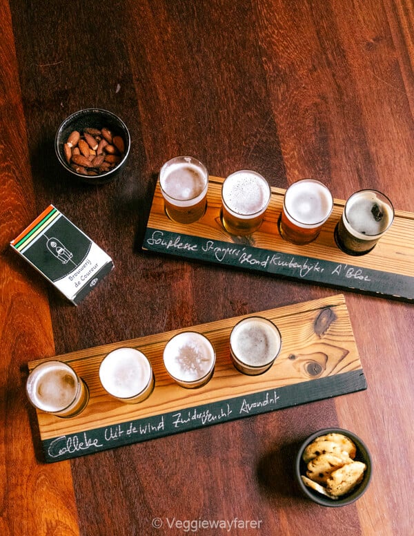 Tasting flight at Brouwerij de Coureur with Souplesse, Strangers Blond, Kuitenbijter and A'Bloe chalked on the board