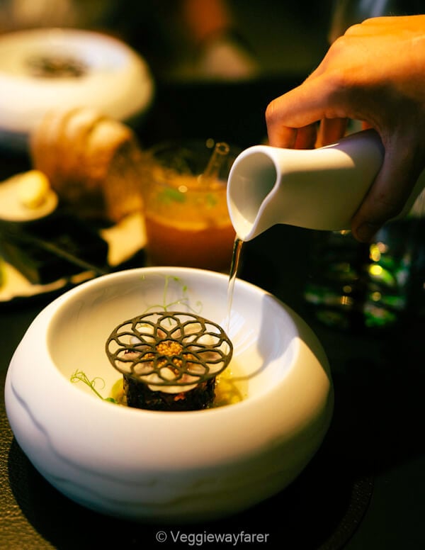 Louvain d'Anvers vegetarian dish. Hand pouring sauce over a white pate