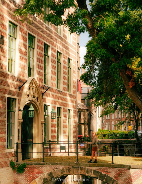 Paushuze building with a little bridge and girl on the bridge in utrecht netherlands
